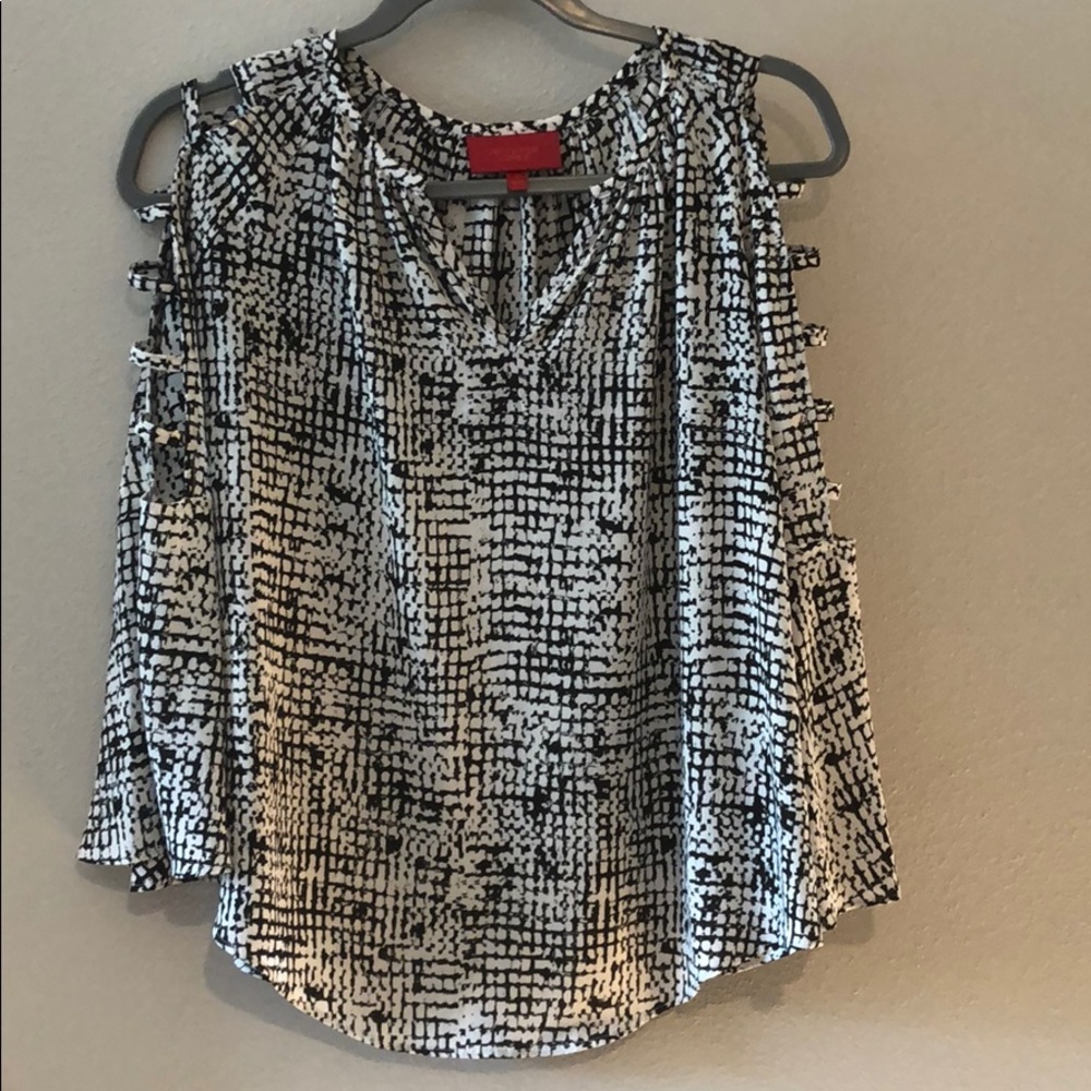 Jennifer Lopez blouse with cut outs on arms.